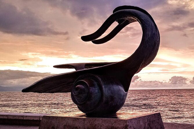Puerto Vallarta Historical El Centro: A Self-Guided Audio Tour - The Malecon lighthouse and a run of public sculpture